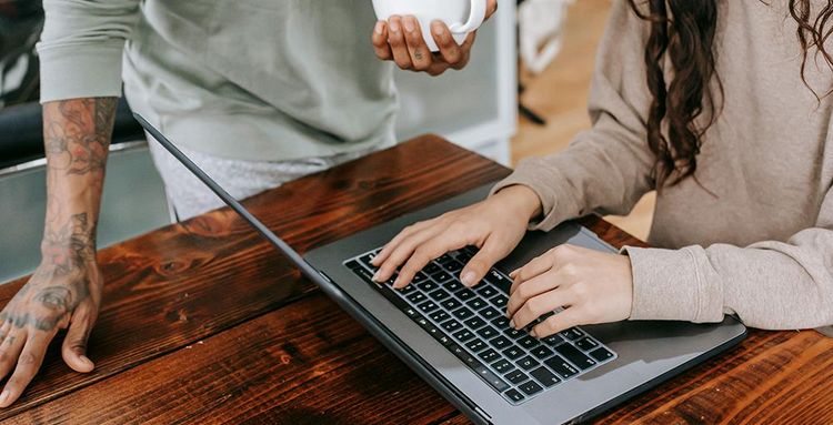 couple using laptop on counter