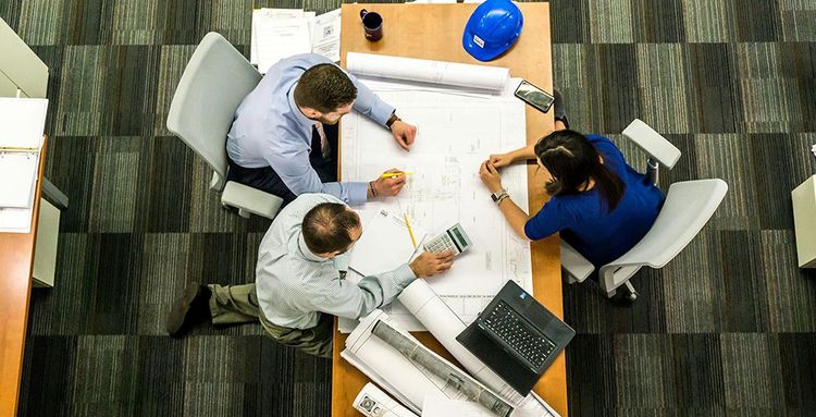 team working together on project at office desk