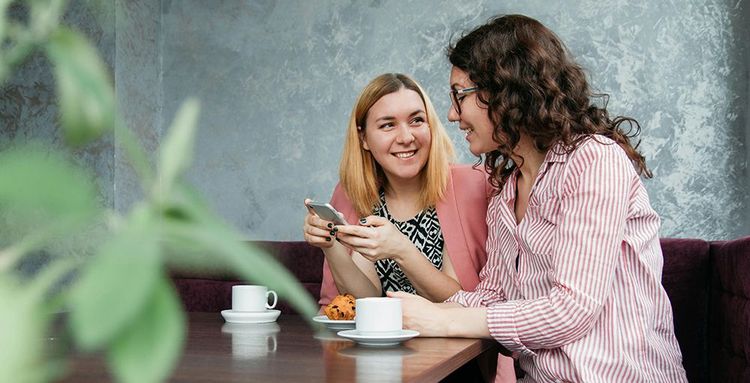 tow women looking at smartphone