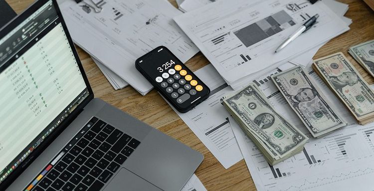 banknotes and calculator on table