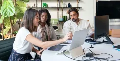 employees reviewing financial wellness program on computer