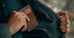 a man holding a wallet in his pocket