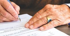 Man Signing Document