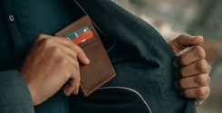 a bank customer holding a wallet in his pocket