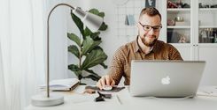 man using financial wellness platform on laptop